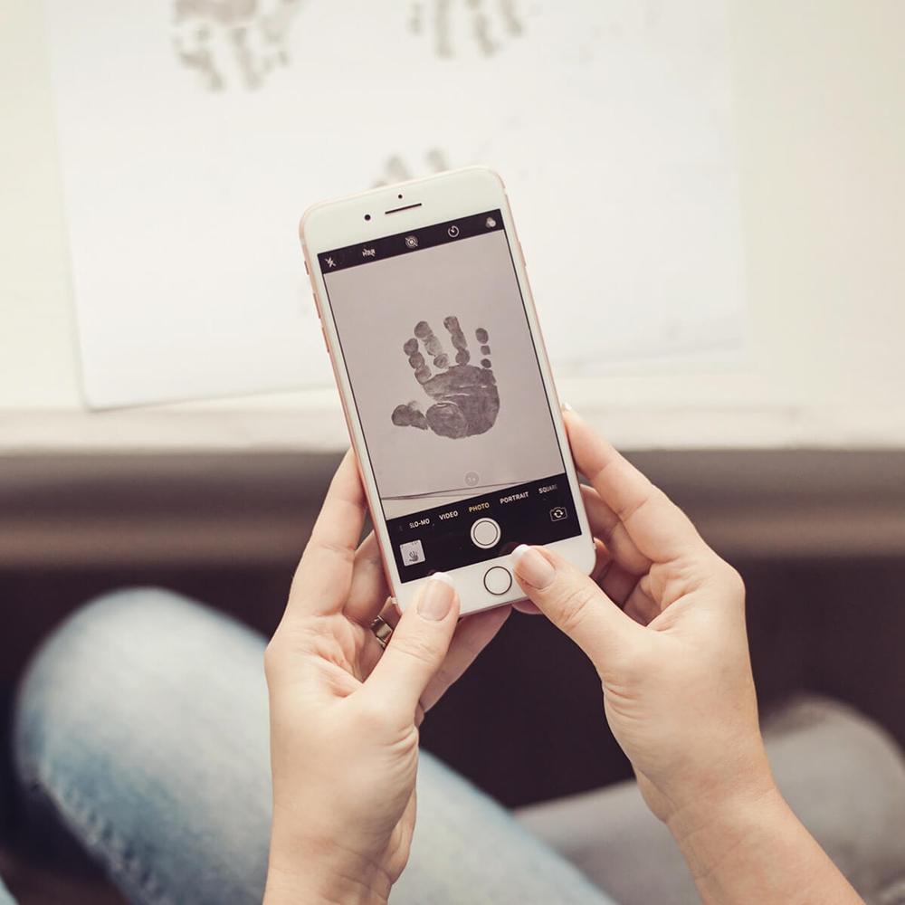 a person taking a photo of a handprint on a smartphone