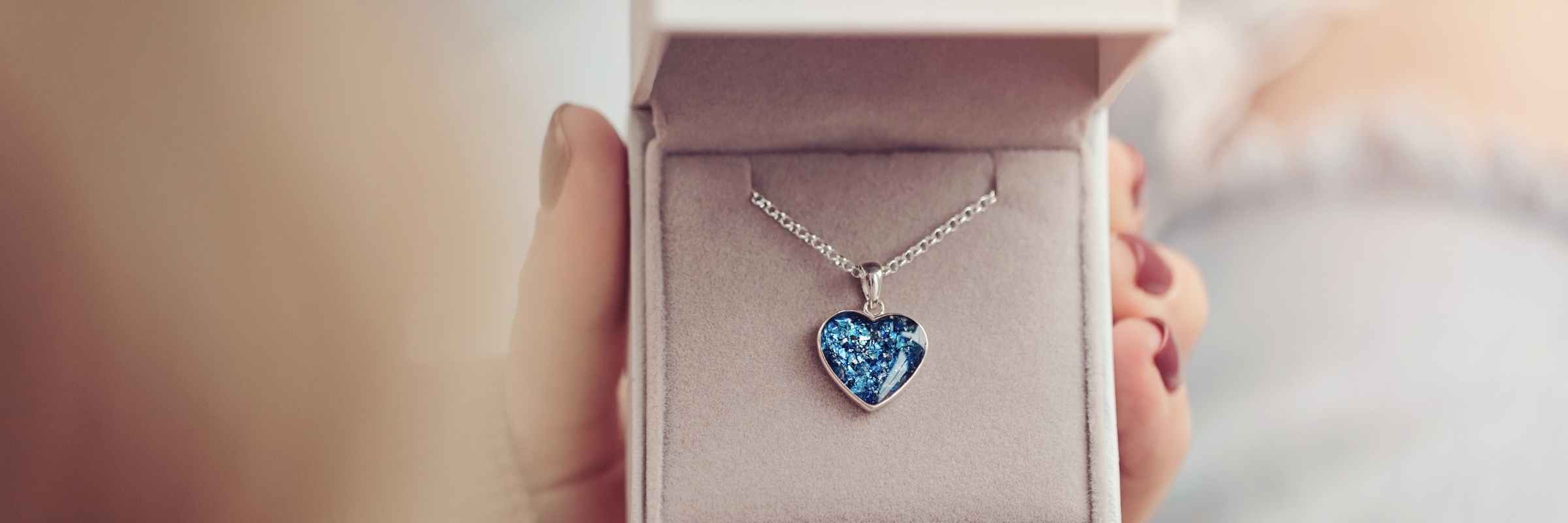 A Blue Heart Necklace created using pet cremation ashes, in a jewellery box