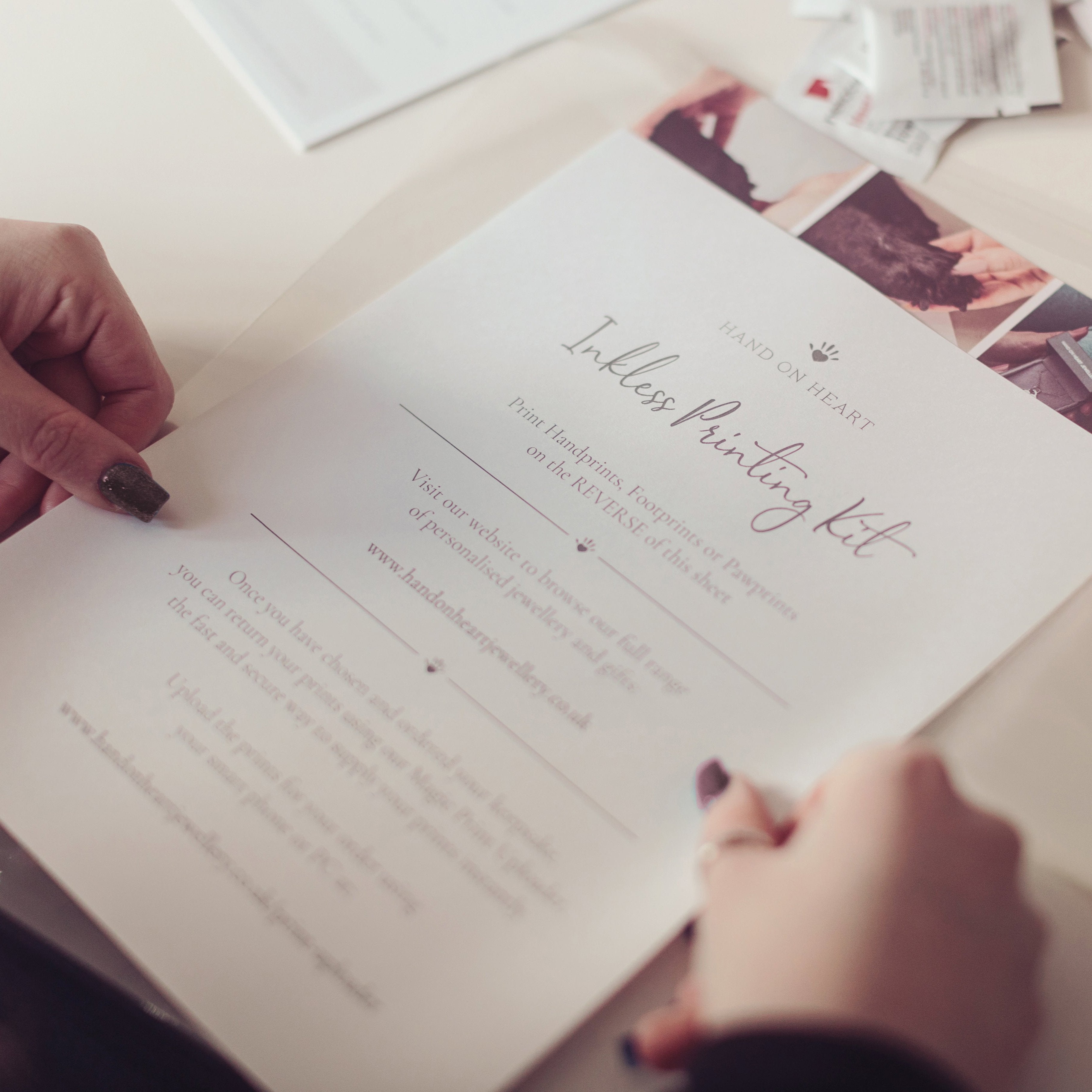 Close up of a person holding an inkless printing kit instruction sheet, designed to capture handprints, footprints or pawprints