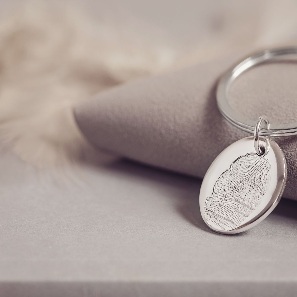 Sterling silver fingerprint keyring featuring a detailed fingerprint engraving on an oval pendant