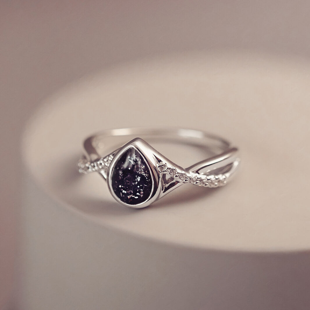 Sterling silver, peardrop shaped ring with a black stone, created using cremation ashes and crystal